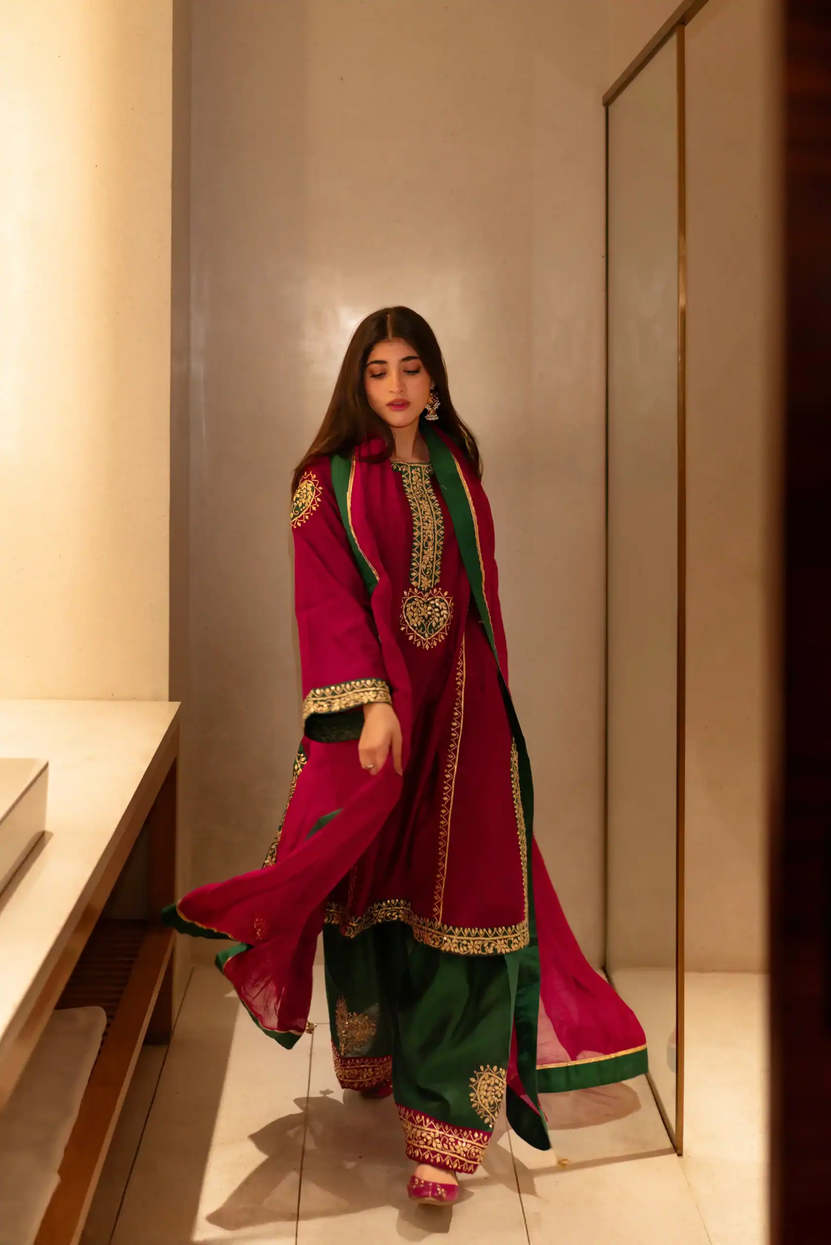 A girl wearing red Gota kinari dress from oni handmade.